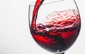 Red wine splashing out of a glass, isolated on white background Royalty Free Stock Photo