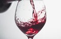 Red wine splashing out of a glass, isolated on white background Royalty Free Stock Photo