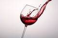 Red wine splashing out of a glass, isolated on white background - Ai Generated Royalty Free Stock Photo