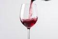 Red wine splashing out of a glass, isolated on white background - Ai Generated Royalty Free Stock Photo