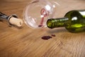 Red wine stain on wooden flooring, dirty wine glass, corkscrew, empty wine bottle Royalty Free Stock Photo