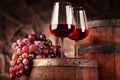 Red wine.Still life two glasses of red wine, grapes and barrel.Selective focus.Wine cellar atmosphere.Copy space Royalty Free Stock Photo