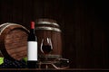 Red wine in tall clear glass beside dark wine bottle. Wine fermentation tank is made of wood. wooden barrel in the cellar, Tasting Royalty Free Stock Photo