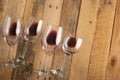 Red wine in transparent wine glasses on a wooden background. Bojole nouveau, wine bar, winery, winemaking, wine tasting concept, Royalty Free Stock Photo