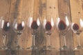 Red wine in transparent wine glasses on a wooden background. Bojole nouveau, wine bar, winery, winemaking, wine tasting concept, Royalty Free Stock Photo