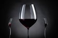 Red wine and two forks. Royalty Free Stock Photo