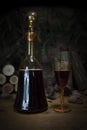 Red Wine Vintage Bottle and Glasses Resting On Wooden Table Against Christmas Background With Wood logs and Pine Branches Royalty Free Stock Photo