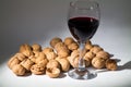 Red wine and walnut on background