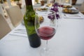 Red wineglass and bottle on dining table at restaurant Royalty Free Stock Photo