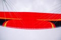 Red wing of a paraglider in the cloudy sky close-up Royalty Free Stock Photo