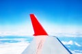 the red wing of the plane on the background of a bright blue sky Royalty Free Stock Photo