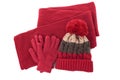 Red winter wool knit hat, scarf and gloves isolated on white background Royalty Free Stock Photo