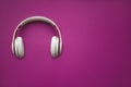 Red wireless headphone on magenta background. top view. space for text Royalty Free Stock Photo