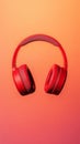 Red wireless headphones floating on gradient background Royalty Free Stock Photo