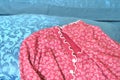 Red woman pajamas on blue sheets