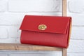 Red woman s leather clutch on the white wall background Royalty Free Stock Photo