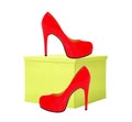 Red woman shoe and yellow gift box isolated on white Royalty Free Stock Photo