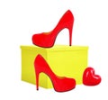 Red woman shoe and yellow gift box isolated on white Royalty Free Stock Photo