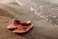 Red women`s beach flip-flops for the sand on the beach Royalty Free Stock Photo