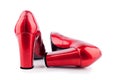 Red women`s shoes with high heels made of lacquered leather back view on a white background  close up Royalty Free Stock Photo