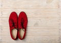 Red women`s shoes oxfords on a light wooden background. Royalty Free Stock Photo