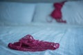 Red women underware on white bed Royalty Free Stock Photo