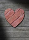 Red wood heart on gray weathered wooden background