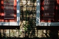 red wood louver window near brick wall covering with mexican daisy. tridax procumbens, coatbuttons plant