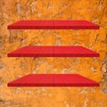 3 Red Wood Shelves Table on orange cement wall