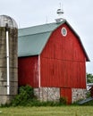 Red Wooden Barn with Silo and Stone Foundation Royalty Free Stock Photo