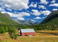 Red Wooden Barn Surrounded By Mountains Near Olderdalen