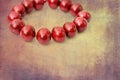 Red wooden beads on a grunge background