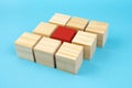 Red wooden block standing out from the group. Divergent views concepts Royalty Free Stock Photo