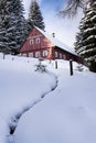 Red wooden cabin in a frosty snowy country Royalty Free Stock Photo