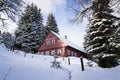 Red wooden cabin in a frosty snowy country Royalty Free Stock Photo