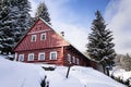 Red wooden cabin in a frosty snowy country Royalty Free Stock Photo