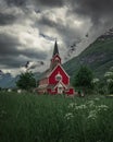 Red wooden church of Olden in the Nordfjord fjord in summer in Norway