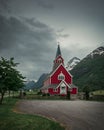 Red wooden church of Olden in the Nordfjord fjord in summer in Norway