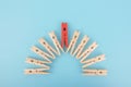 Red wooden clothespin - standing out from the crowd, concept of difference