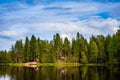 Red wooden cottage by the lake Royalty Free Stock Photo