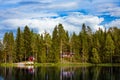 Red wooden cottage by the lake Royalty Free Stock Photo