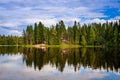 Red wooden cottage by the lake Royalty Free Stock Photo