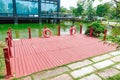 Red wooden deck platform outdoor wood floor backyard patio park terrace Royalty Free Stock Photo