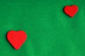 Red wooden decorative hearts on green cloth background Royalty Free Stock Photo