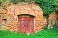 Red wooden door to an old wine cellar Royalty Free Stock Photo