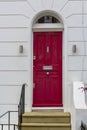 Red Wooden Entrance Door to residential building in London. Typical door in the English style. Royalty Free Stock Photo