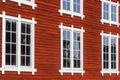 Red wooden facade with beautiful windows