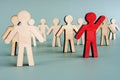 Red wooden figure in the crowd. Leadership development concept. Royalty Free Stock Photo