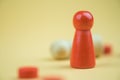 A red wooden figure standing with person figure lie on floor. Business strategy