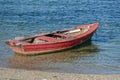 Red wooden fishing boat moored on the shore Royalty Free Stock Photo